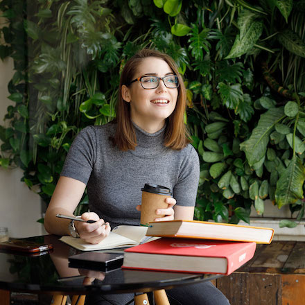 Girl sitting at table with books