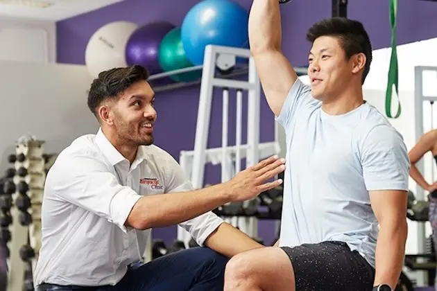 Student with patient in gym