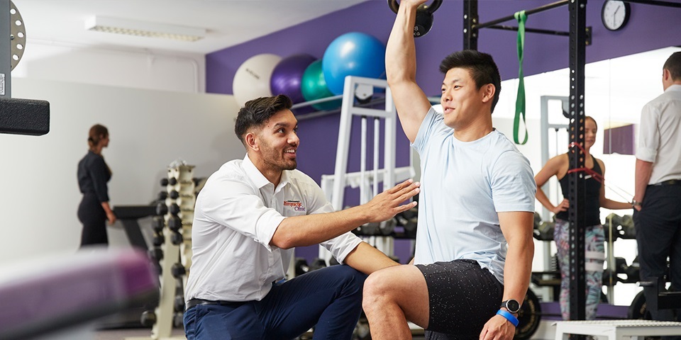 Student with patient in gym