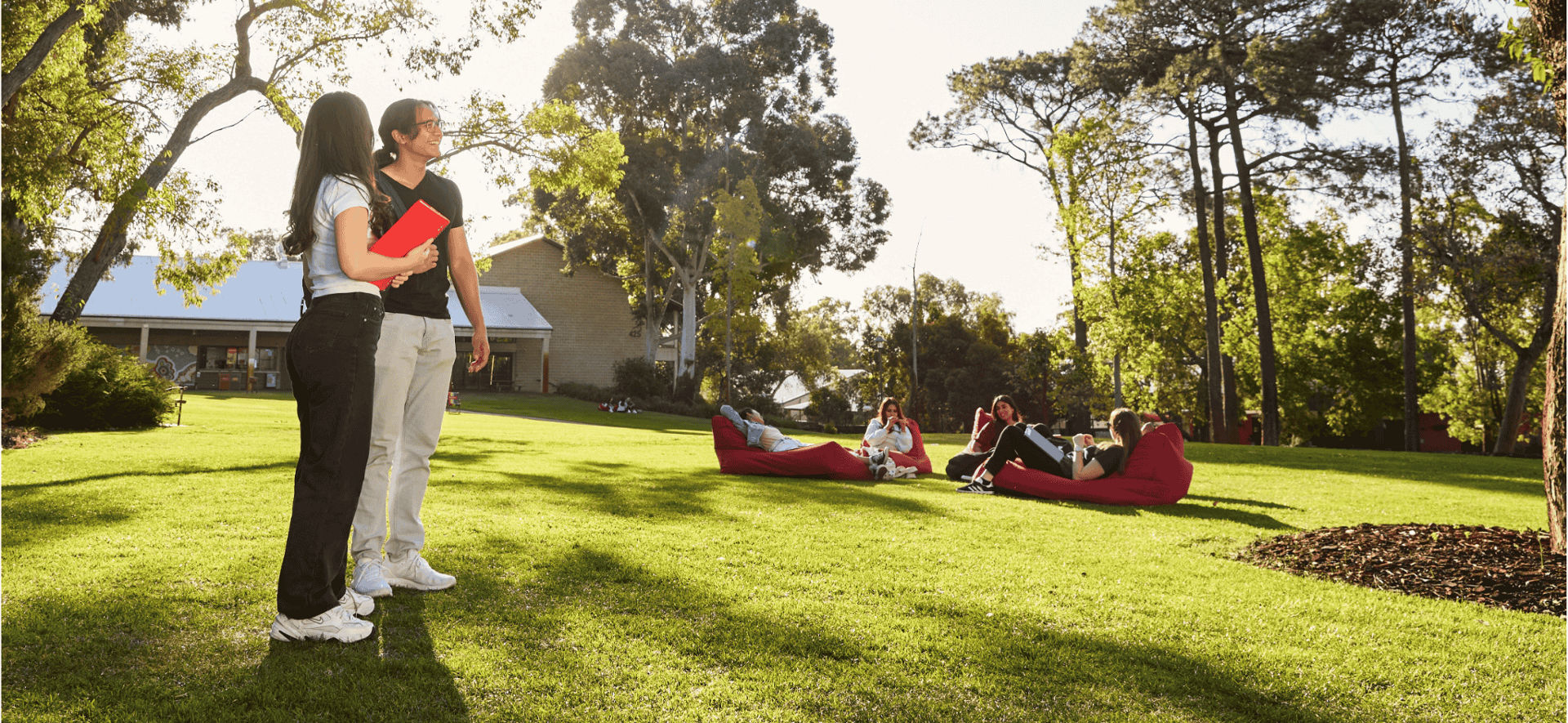 2 students together with beanbags in background on Bush Court