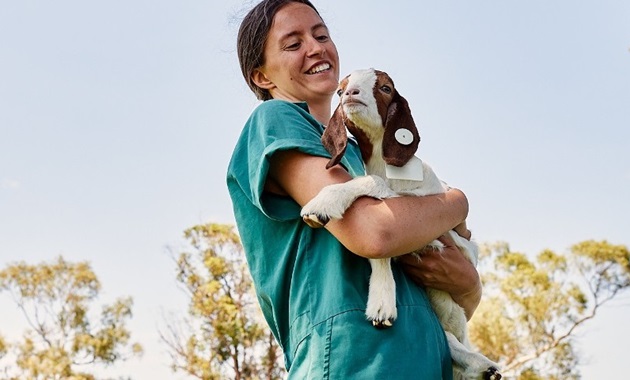 Vet student holding goat