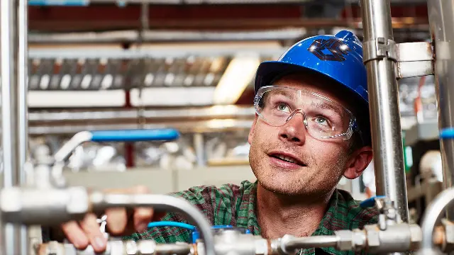 Engineer fixing working on metal pipes
