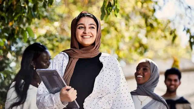 Girl walking with laptop