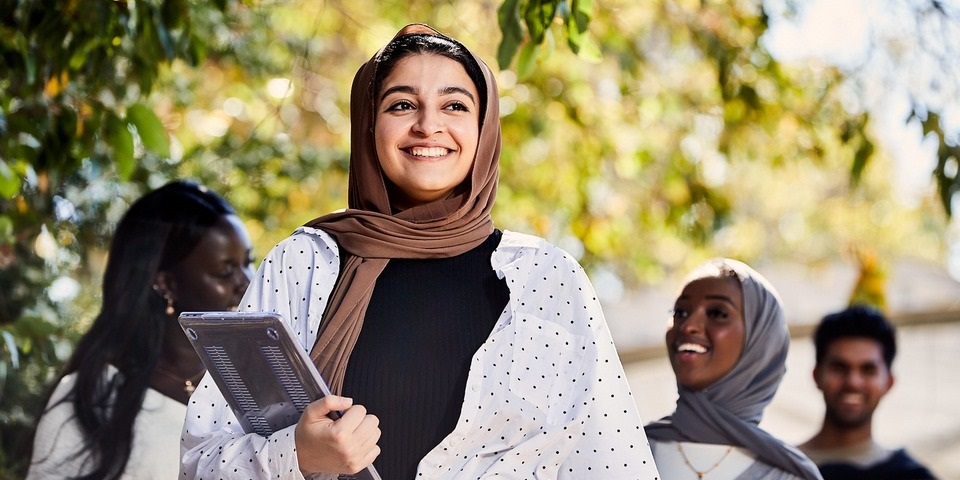 Girl walking with laptop