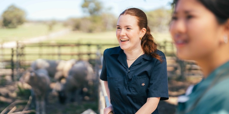 Young female students smiling on Uni farm