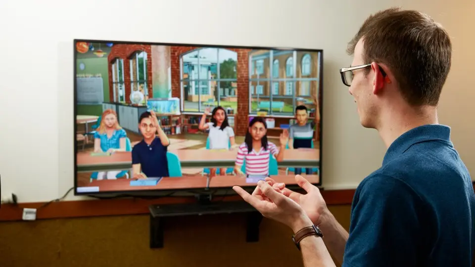 Teaching student taking a class with SimLab.