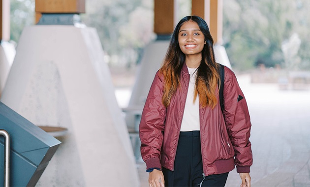 Young student walking outside on campus