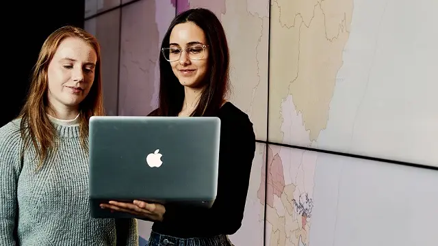 Murdoch University students holding laptop