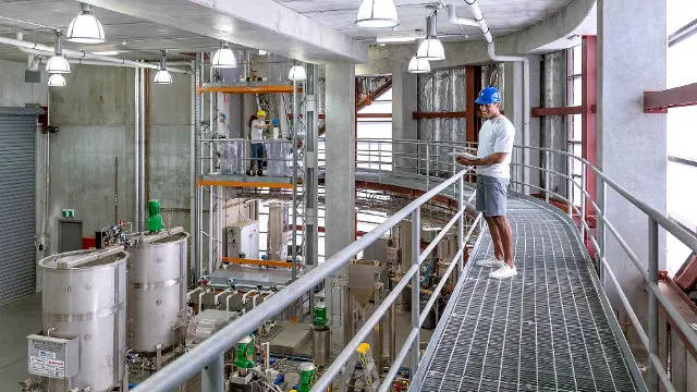 Engineering students in hardhats working in the Bayer pilot plant