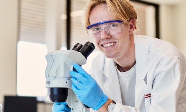 Man looking through microscope