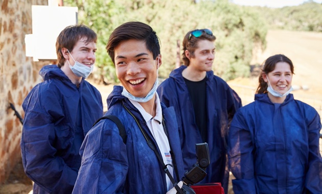 Murdoch forensics students in protective clothing out in the field.