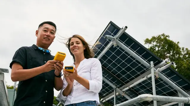 Murdoch University students in front of solar panels