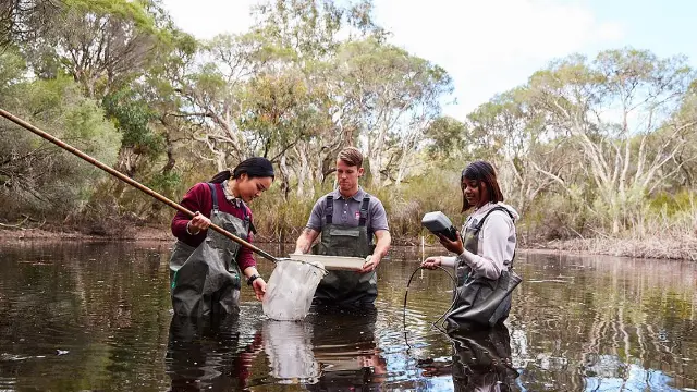 Agricultural Science researcher with a sample.