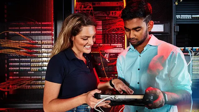 Murdoch University information technology students holding network device in server room