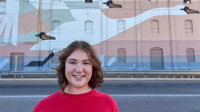 Regional student Kate Gentle standing in front of the Northam Flour Mill