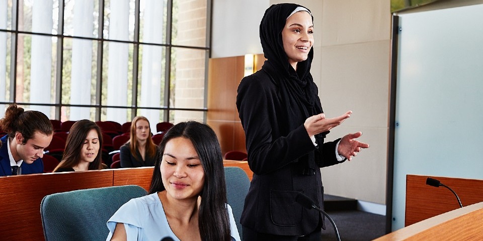 Female law student standing in courtroom