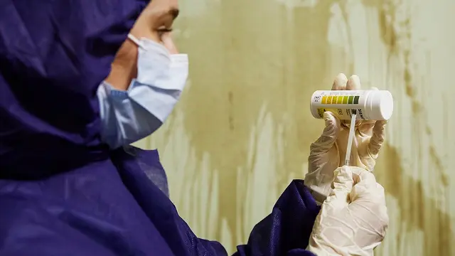Murdoch University forensic student holding container