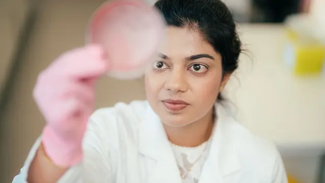 Murdoch University researcher holding petridish