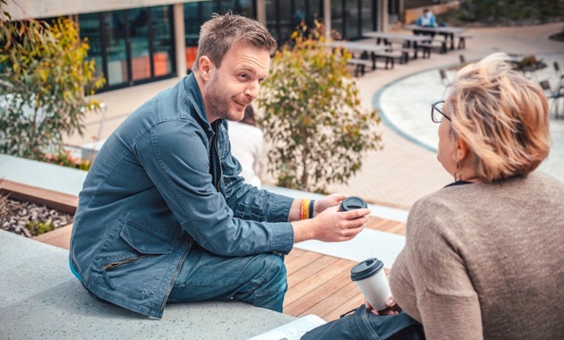 Mature age students talking in the winter garden.