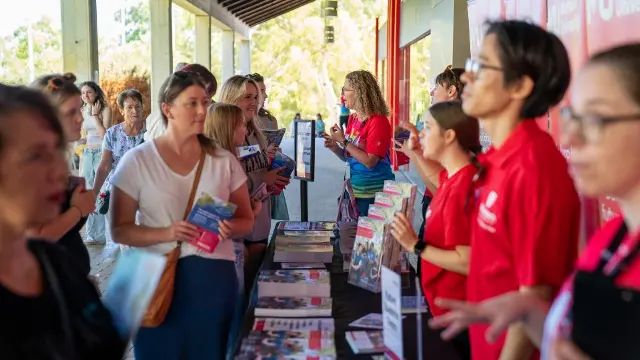 visitors talking to university representatives