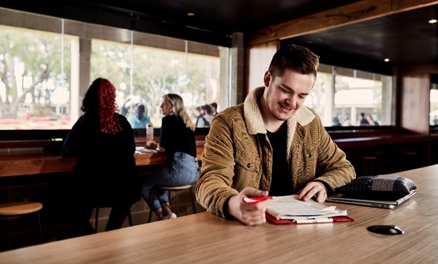 student studying at cafe