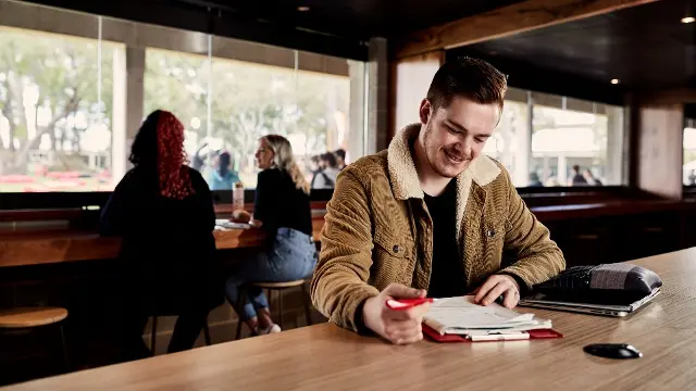 student studying at cafe