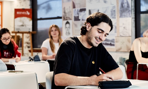 male student with two female students in background