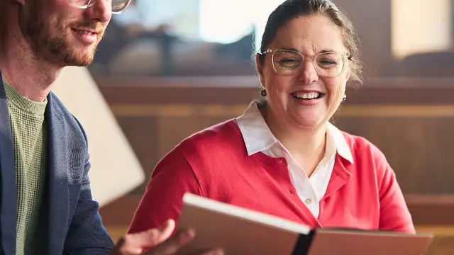 Staff looking at a textbook