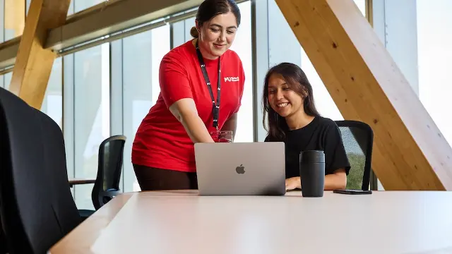 Student Central team helping student with laptop