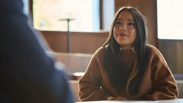 Student sitting at table with notes