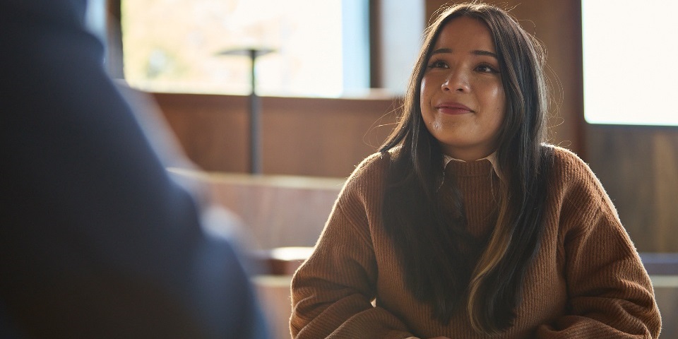 Student sitting at table with notes