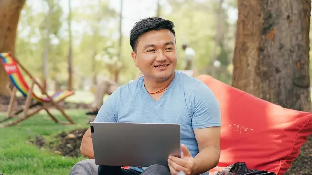 Student sitting on beanbag with laptop on Bush Court