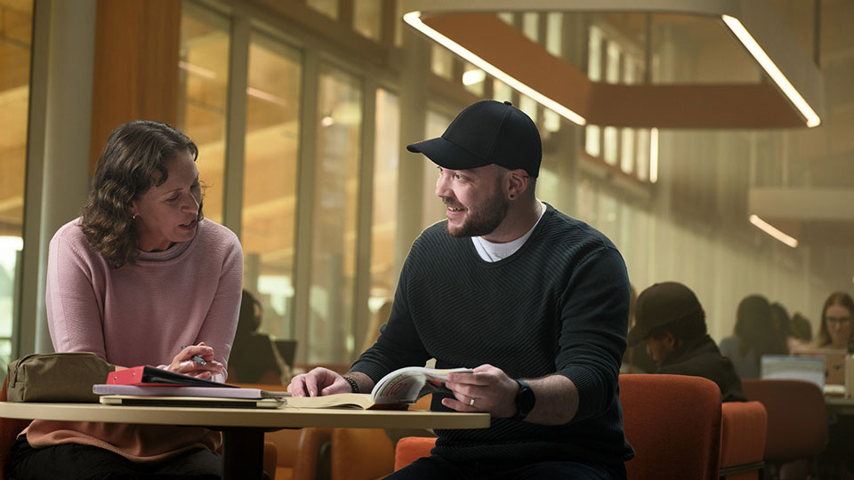 Two Murdoch students studying together in the library