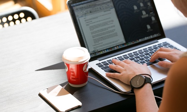 Student typing on laptop