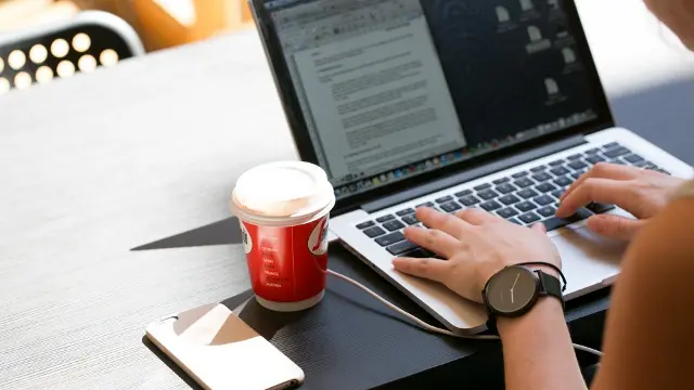 Student typing on laptop