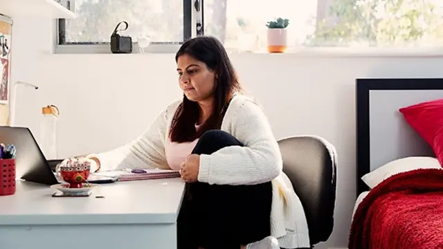 Murdoch University student using laptop in student village