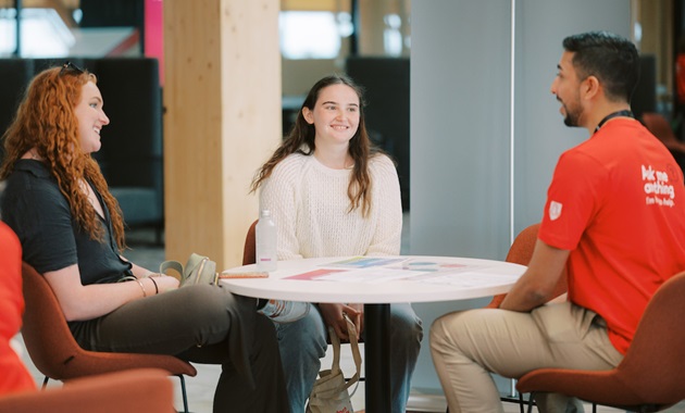 student talking to support staff