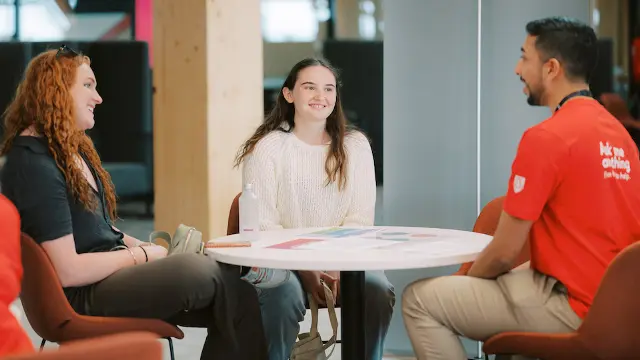 student talking to support staff