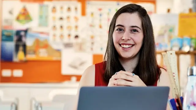 Teaching student at desk.