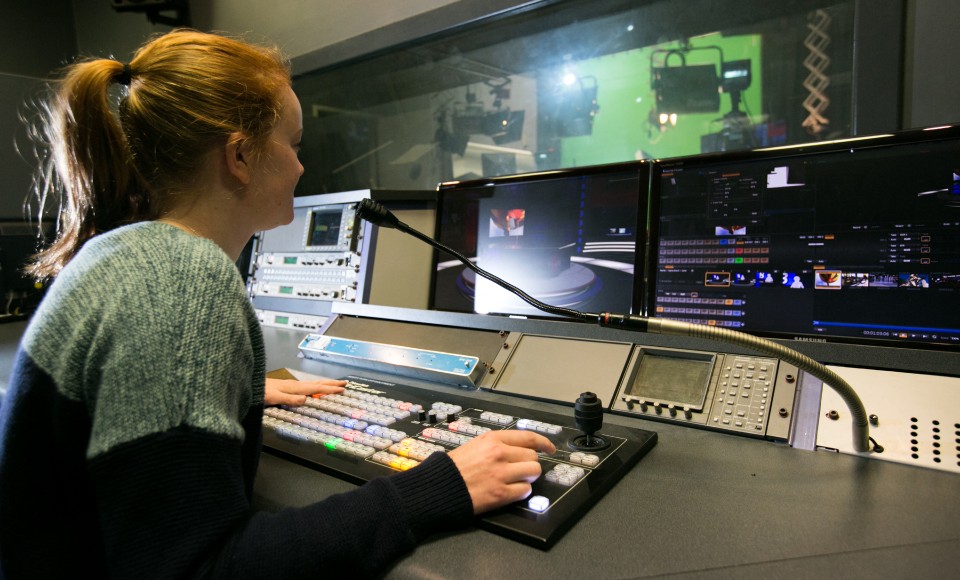Student working in TV studio control room.
