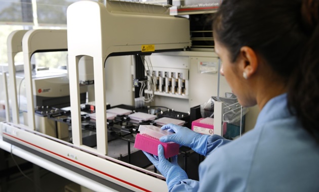 A health researcher in a laboratory working with samples.