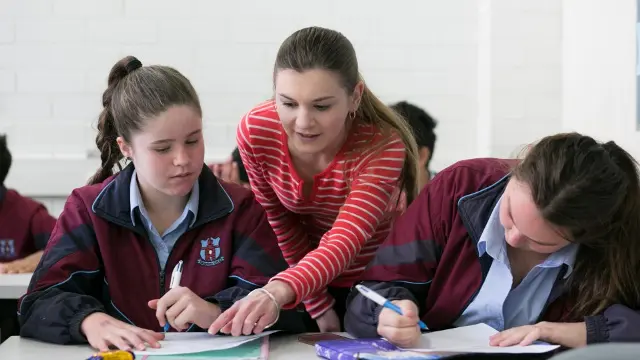 High school teacher with students in the classroom.