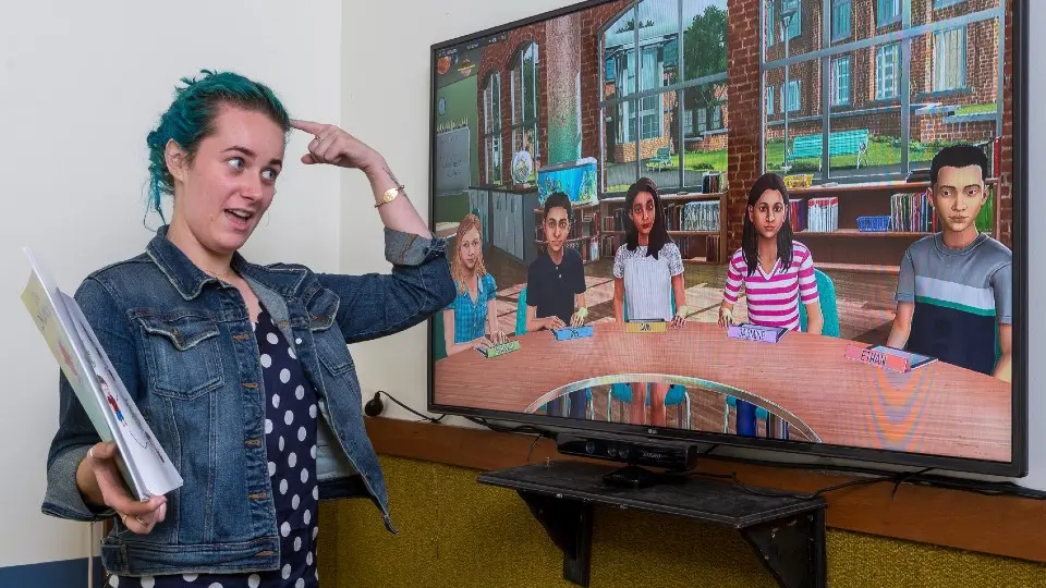 A teaching student reading a book to a classroom of children using SimLab.