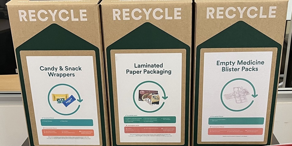 Three recycling boxes at Mandurah Campus Library, labelled from left to right: Candy & snack wrappers; laminated paper packaging; empty medicine and blister packs.