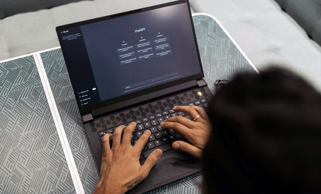 An open laptop with the ChatGPT homepage displayed.