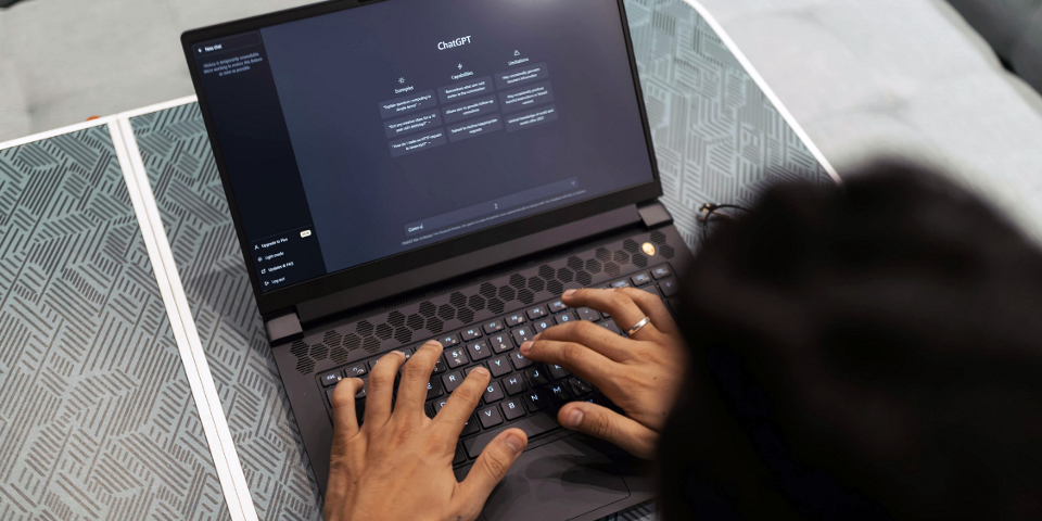 An open laptop with the ChatGPT homepage displayed.