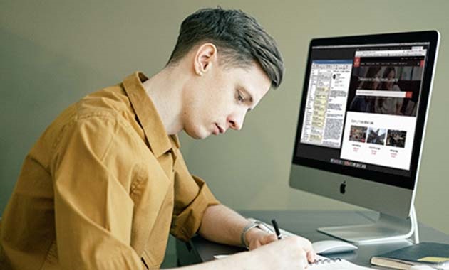 Student studying at desk with computer