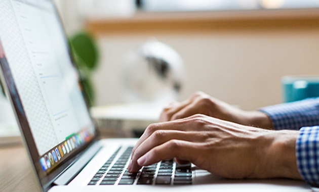 Person typing on laptop