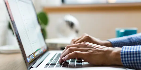 Person typing on laptop