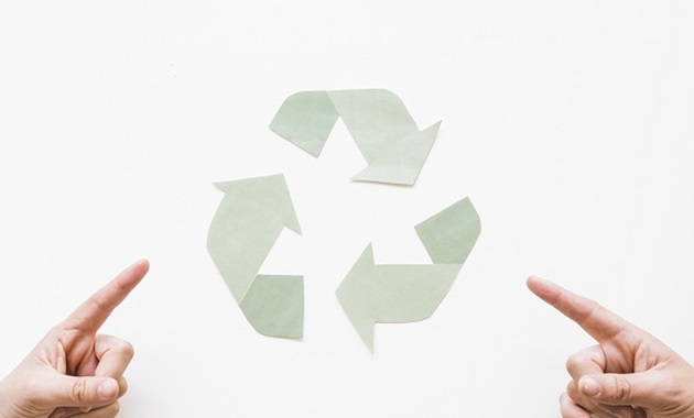 two hands pointing at a recycle symbol